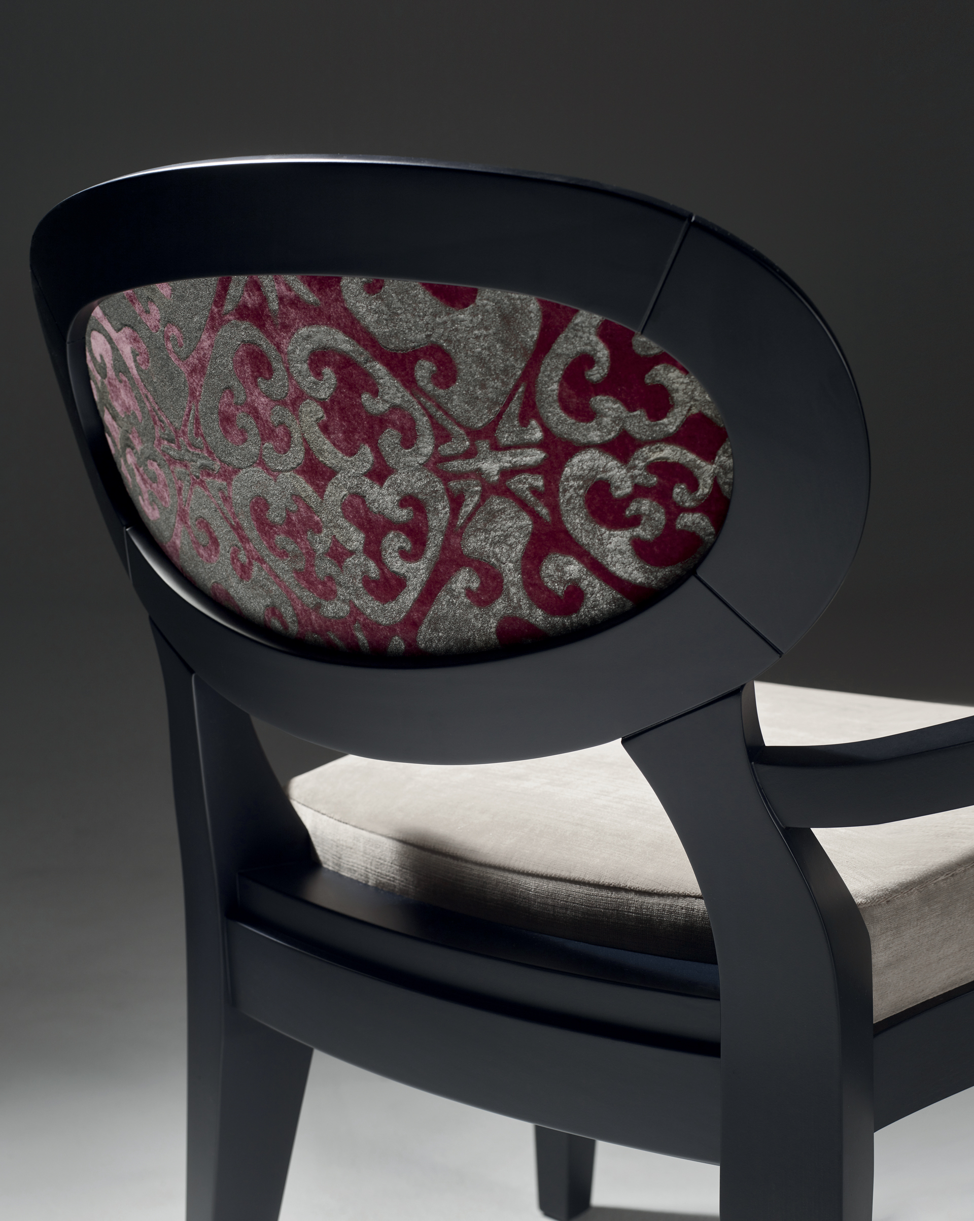 Back detail of Anima, a wooden and fabric or leather dining chair available with different combinations of fabrics and colors, from Promemoria's catalogue | Promemoria