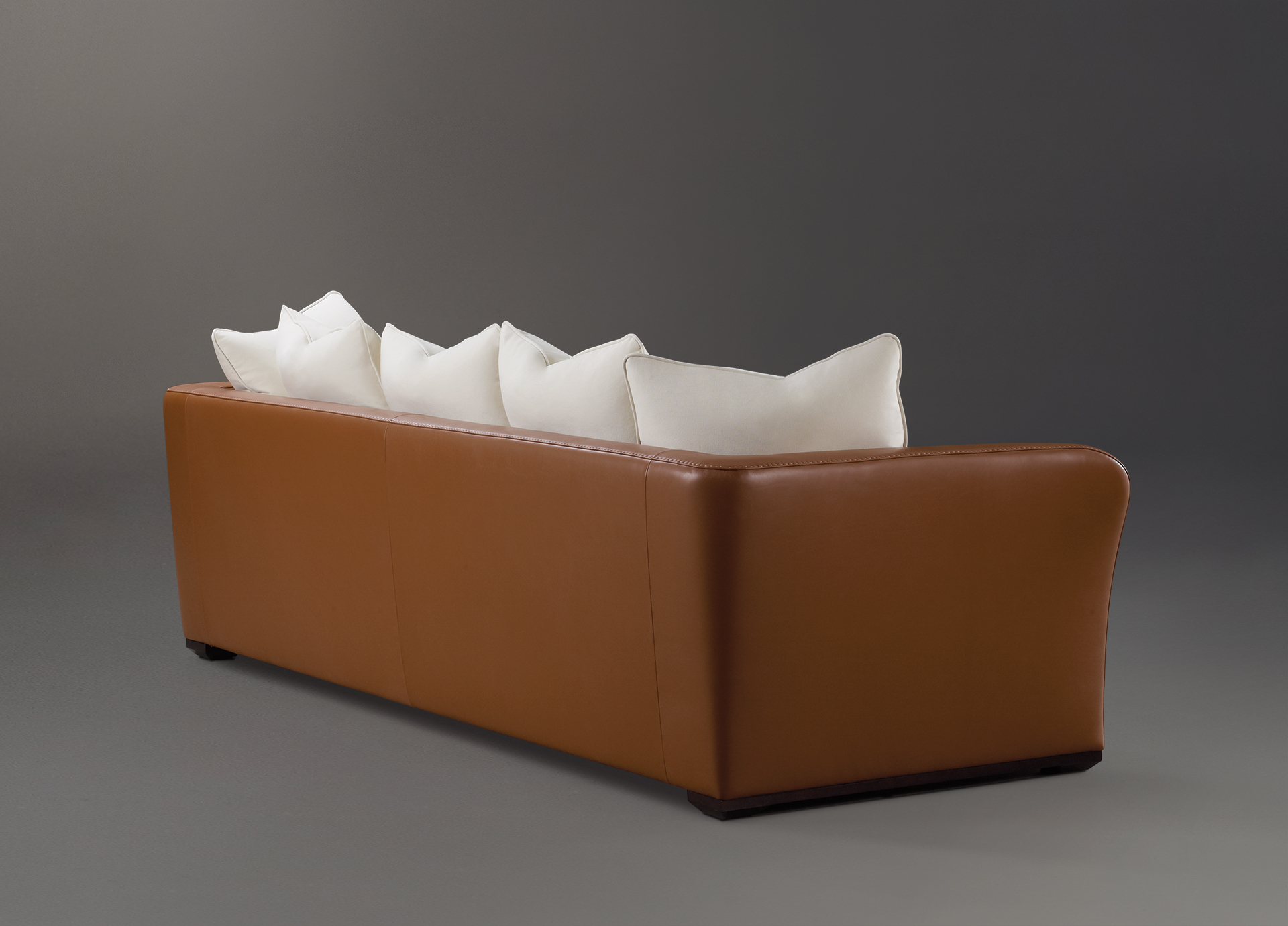 Shangri-la is a wooden sofa covered in leather and fabric, from Promemoria's catalogue | Promemoria