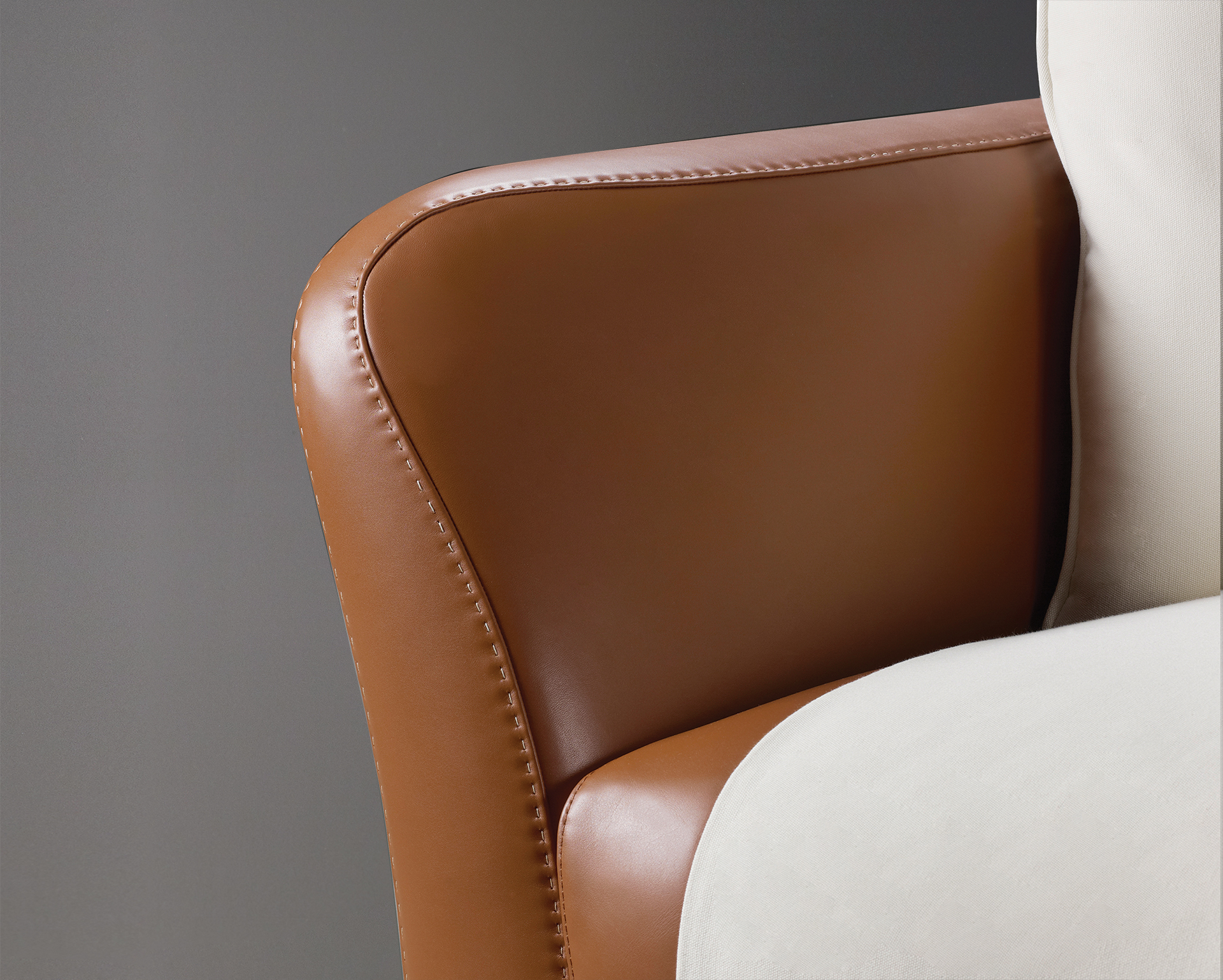 Leather detail of Shangri-la, a wooden sofa covered in leather and fabric, from Promemoria's catalogue | Promemoria