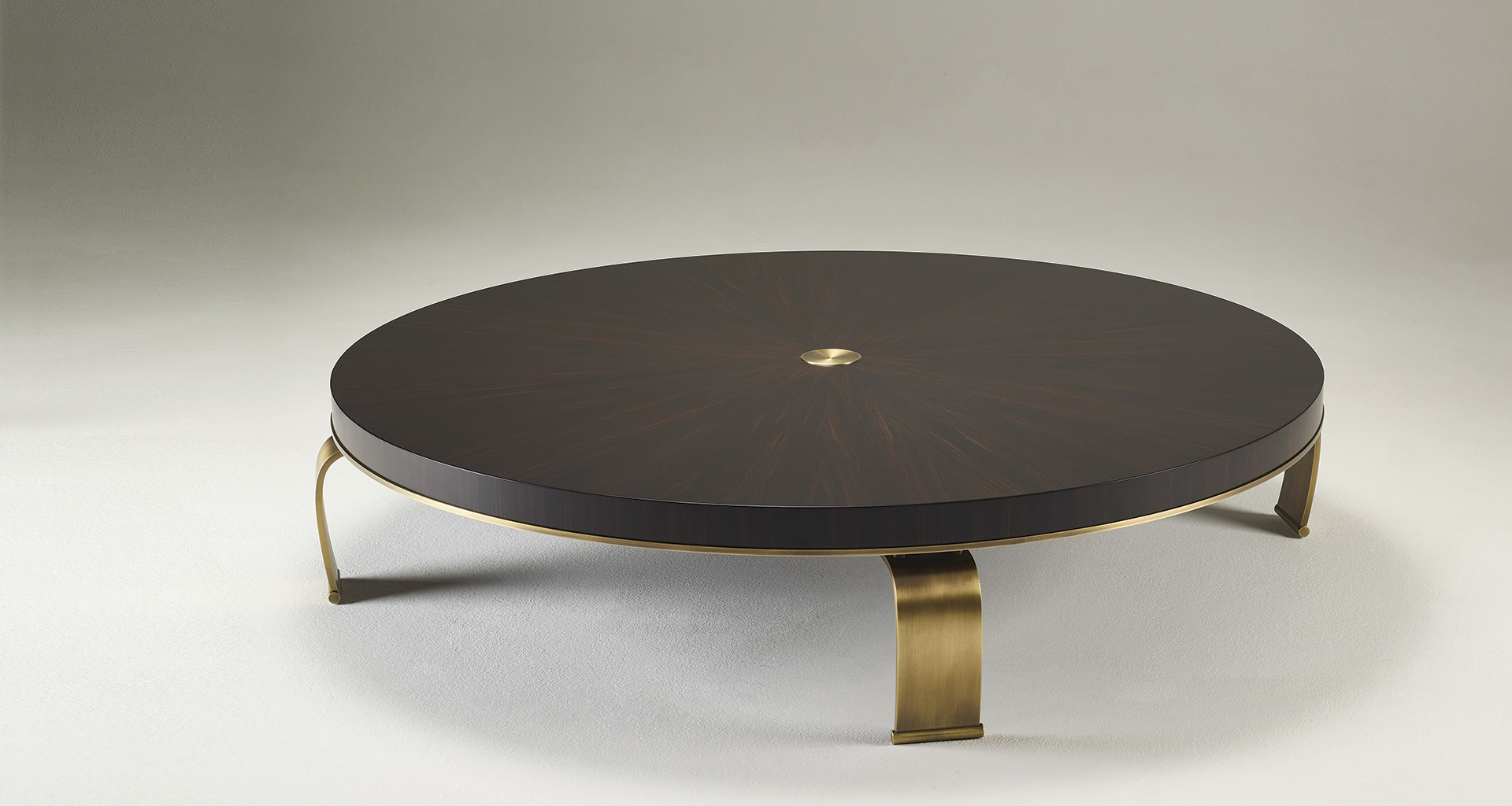 Sumo is an oval, rectangular or circular coffee table with wooden top and bronze legs, from Promemoria's Sun Tales collection | Promemoria